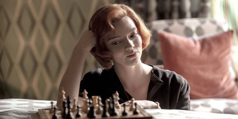 Beth looking down at a chess board in The Queen's Gambit.