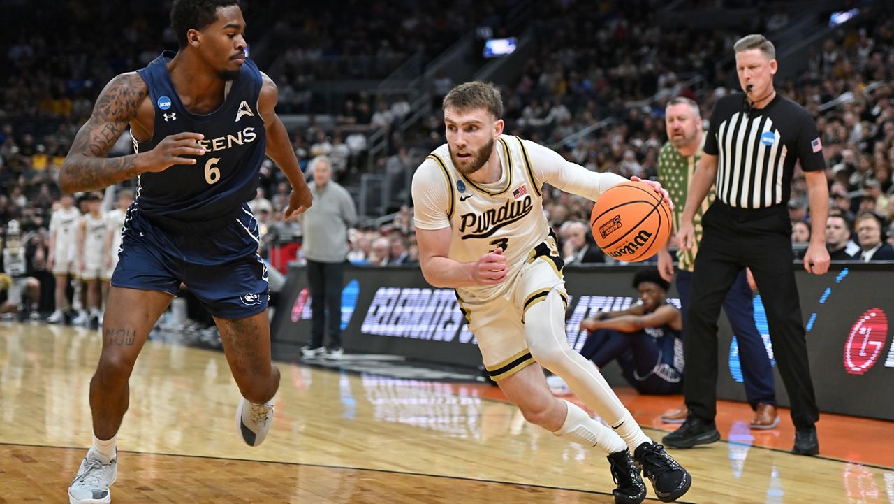 Purdue's Braden Smith (3) drives to the basket past Queens University's Avantae Parker (6) during the first round of the NCAA college basketball tournament Friday, March 20, 2026, in St. Louis. (AP Photo/Ali Overstreet)