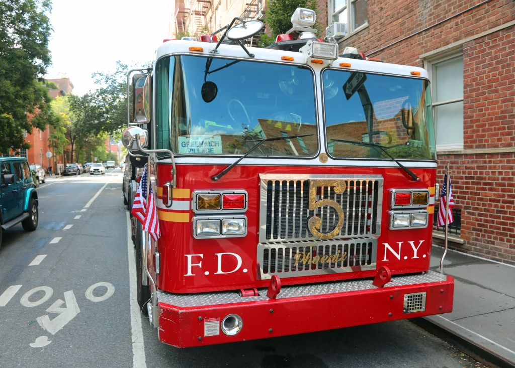 A red New York Fire Department Engine Number Five truck parked on the street in Greenwich Village.