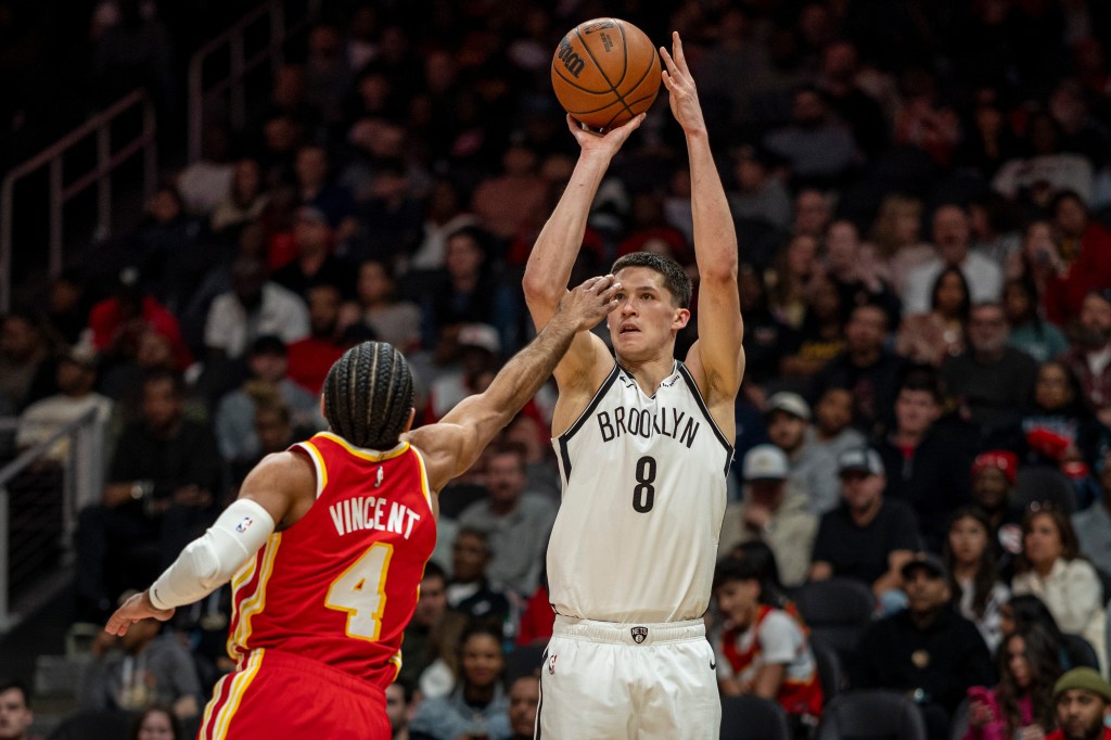 Brooklyn Nets guard Egor Dëmin (8) shoots a 3-point basket against Atlanta Hawks guard Gabe Vincent (4).