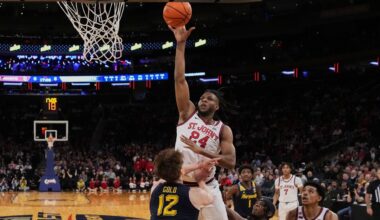 St. John's forward Zuby Ejiofor (24) looks to pass around Seton Hall center Najai Hines (25) during the first half of an NCAA college basketball game Friday, March 6, 2026, in Newark, N.J.