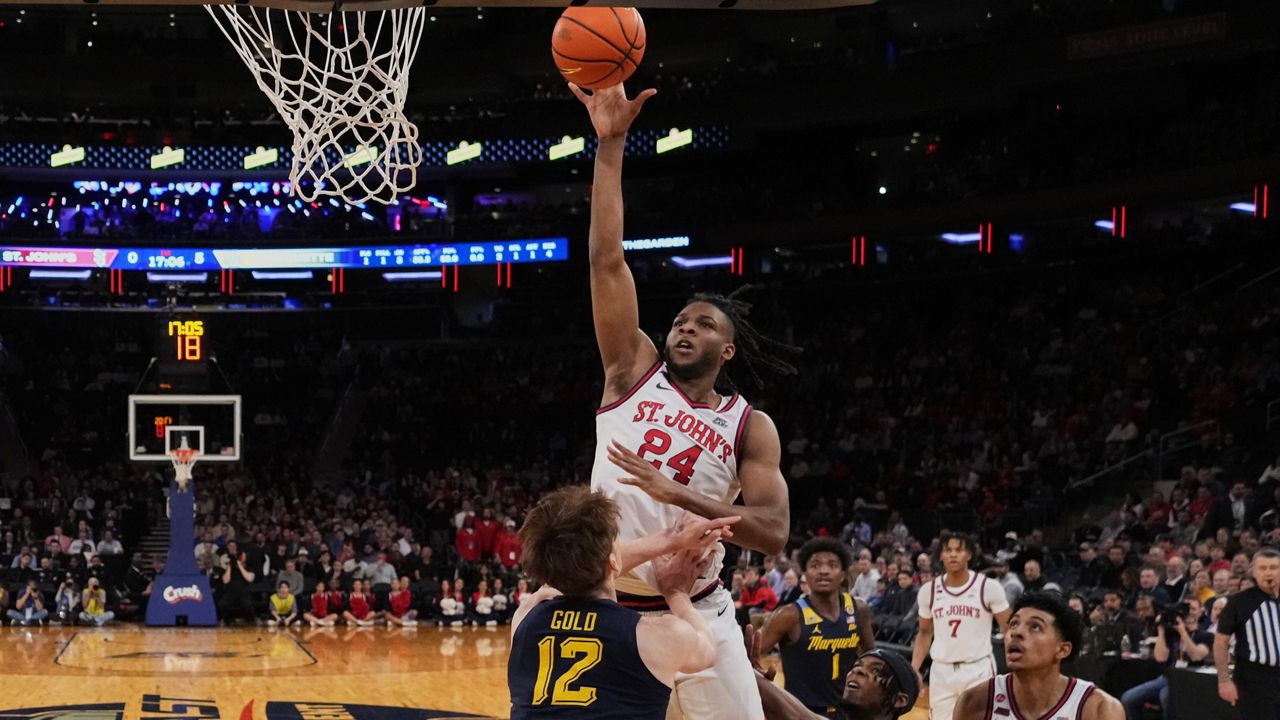 St. John's forward Zuby Ejiofor (24) looks to pass around Seton Hall center Najai Hines (25) during the first half of an NCAA college basketball game Friday, March 6, 2026, in Newark, N.J.