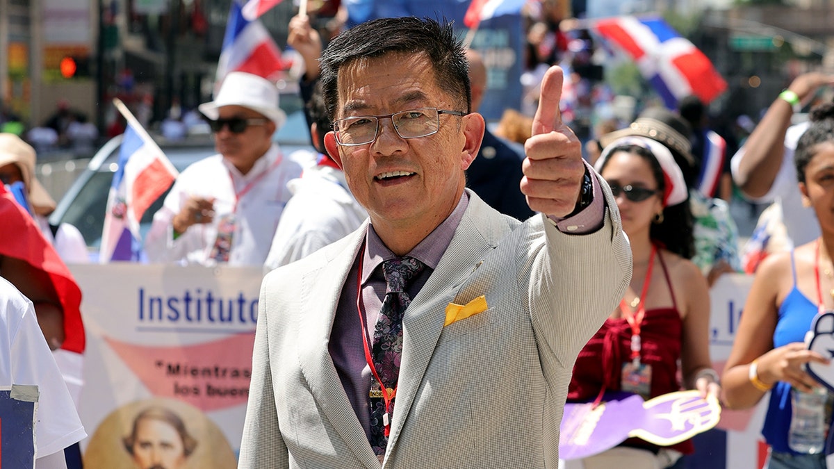 New York State Senator Steve Chan marching along Avenue of the Americas during Dominican Day Parade in Manhattan