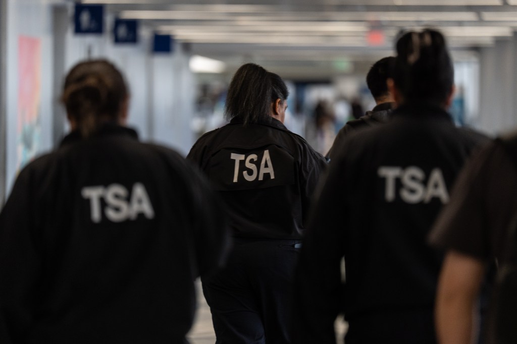 TSA agents walk through a terminal at Los Angeles International Airport.