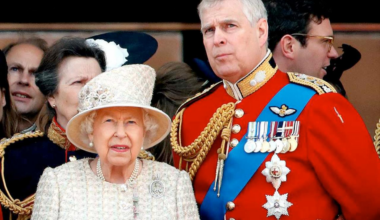 Queen Elizabeth II and then-Prince Andrew watch a flypast from the balcony of Buckingham Palace during the Queen