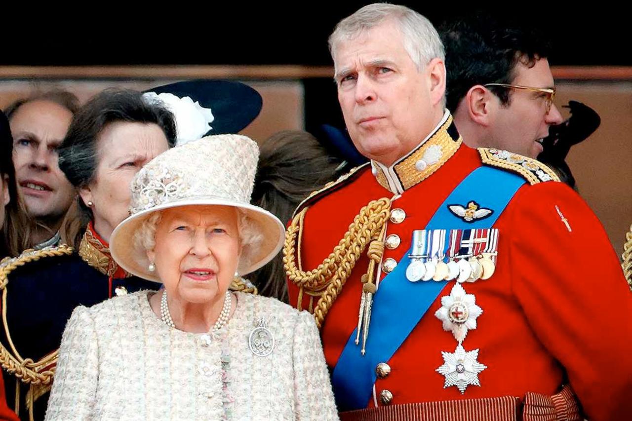 Queen Elizabeth II and then-Prince Andrew watch a flypast from the balcony of Buckingham Palace during the Queen