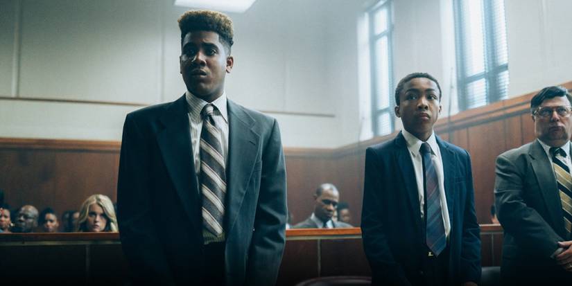 Korey and Kevin stand in suits, in a courtroom, in 'When They See Us'
