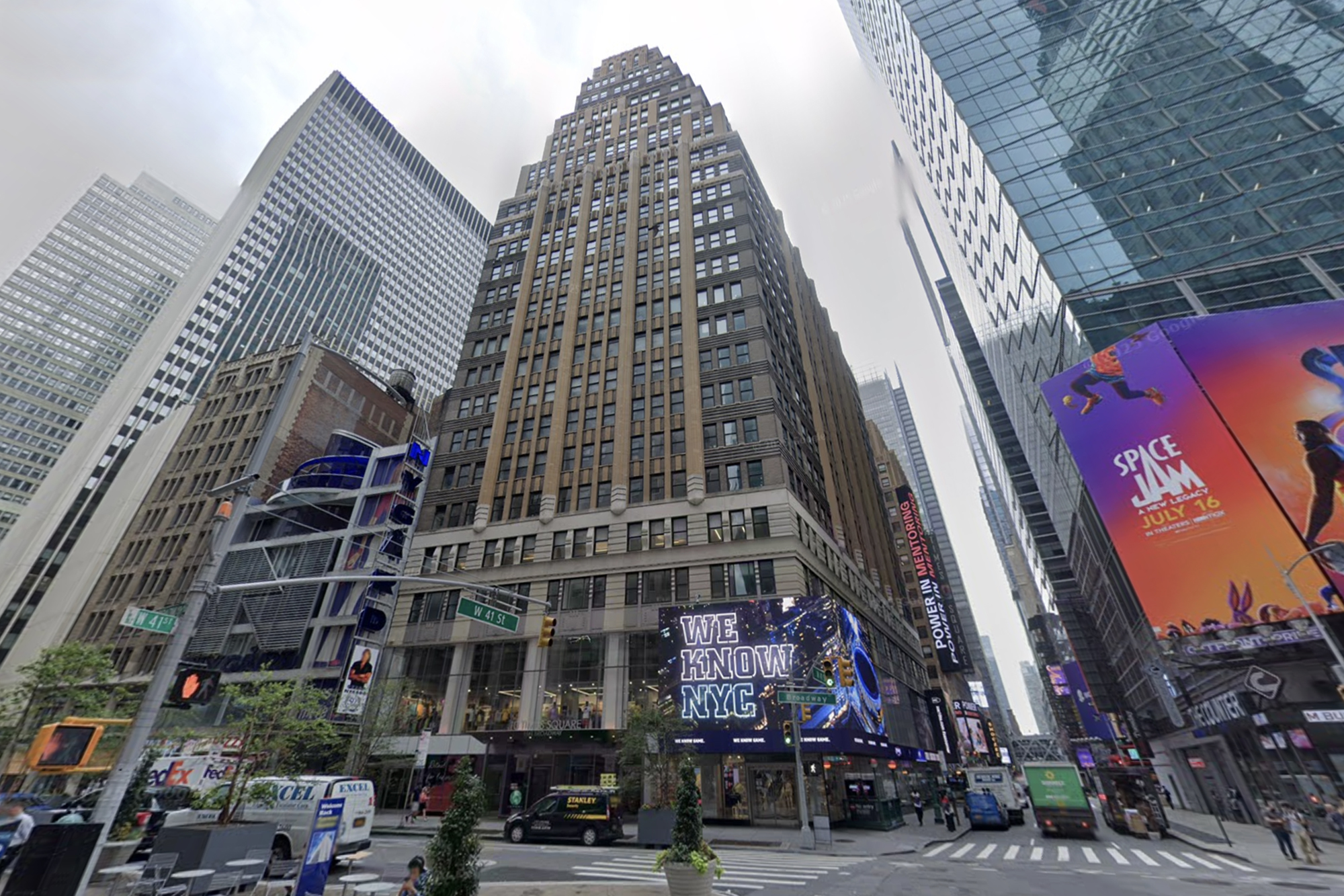 Street view of Times Square with billboards, including "We Know NYC" and "Space Jam: A New Legacy."