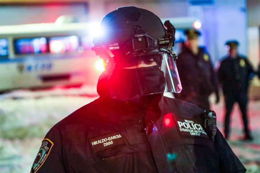 An NYPD Strategic Response Group officer helps to police an anti-ICE protest in Manhattan