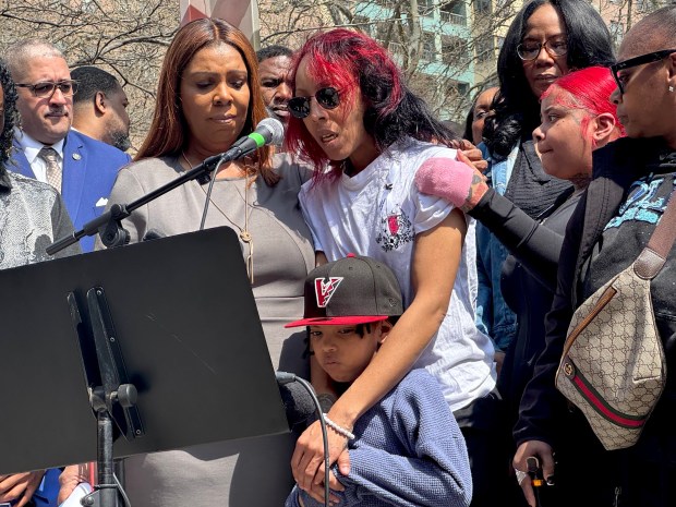New York Attorney General Letitia James, left, looks on as Christina Poitier, the grandmother of baby Kaori Patterson-Moore, speaks during a memorial on Saturday, April 4, 2026, at the site where she was killed on Moore and Humboldt Sts. in Brooklyn. 