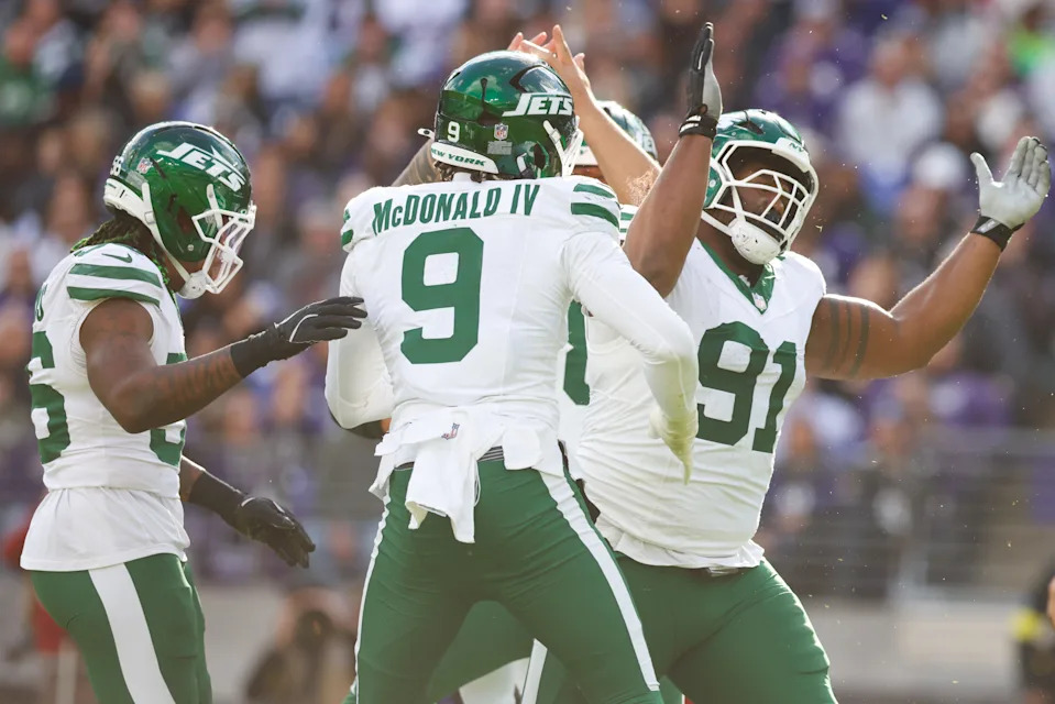 New York Jets defensive tackle Jowon Briggs (91) and New York Jets defensive end Will McDonald IV (9) celebrate a sack.