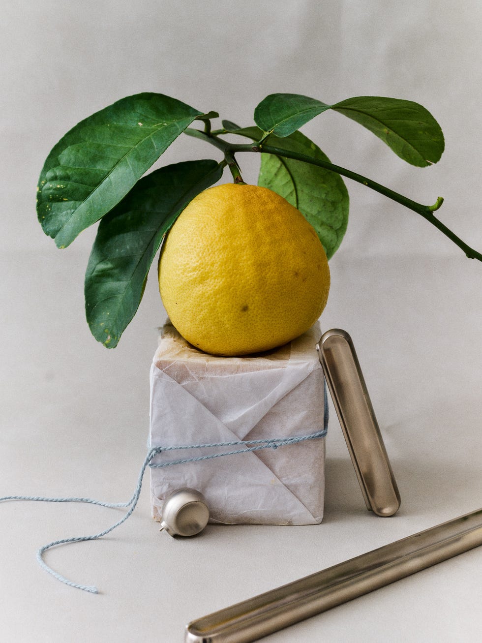 Lemon on a wrapped box with silver utensils.