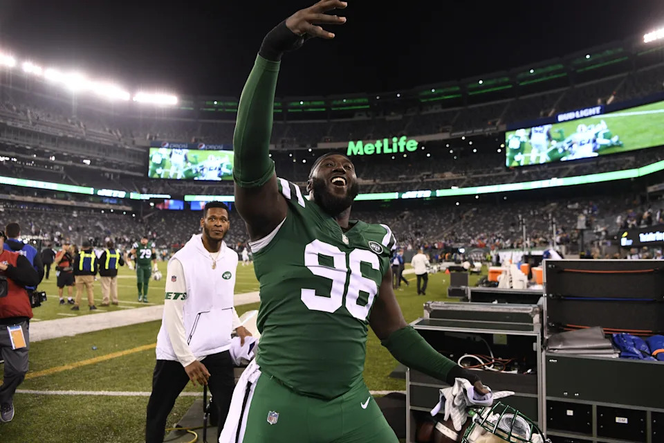 New York Jets defensive end Muhammad Wilkerson walks off the field to cheering fans.