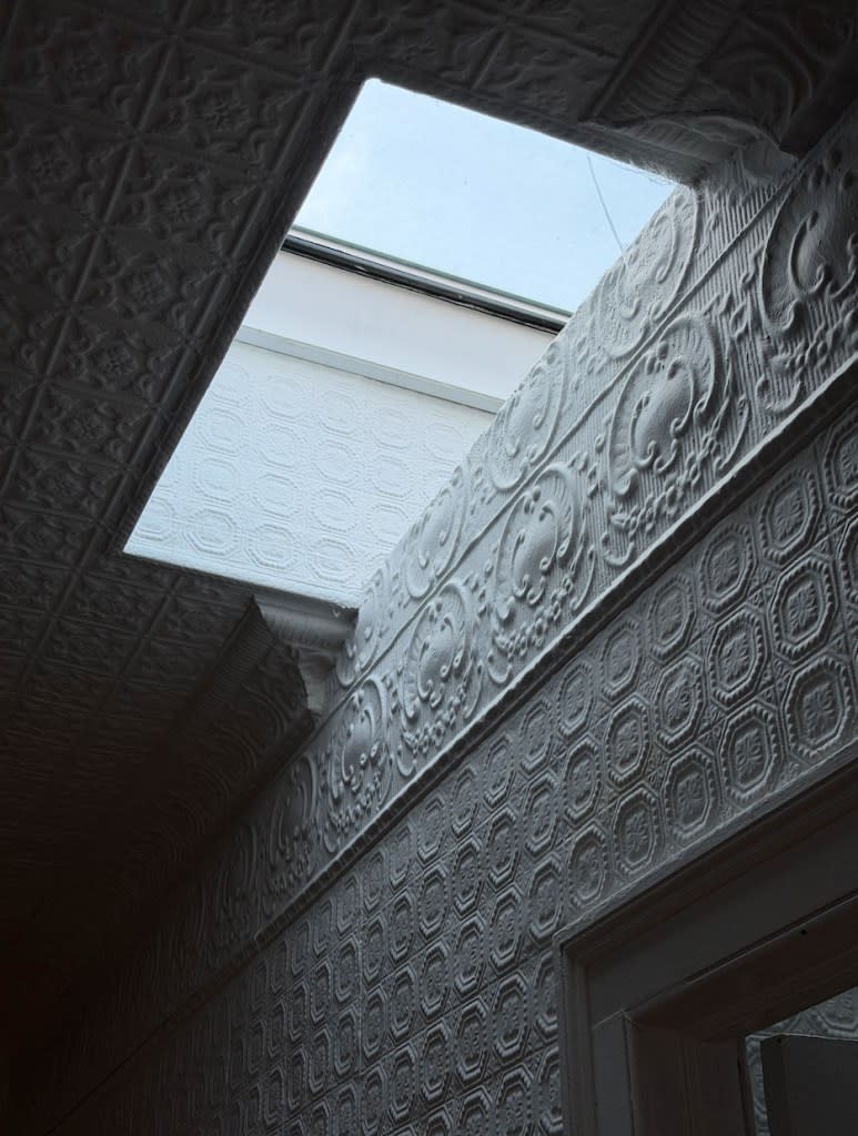 What sets it apart isn’t just the address, but how much of it is still intact: original carriage and hay doors, tin ceilings, worn-in hardwood floors and cast-iron radiators that give it a true time-capsule feel. Compass