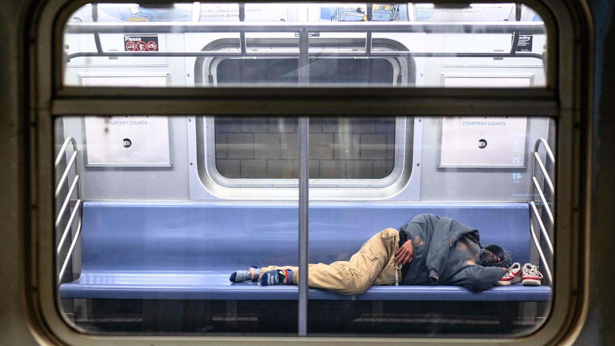 A man named Victor J. Blue sleeping on the E train subway in Queens, New York.