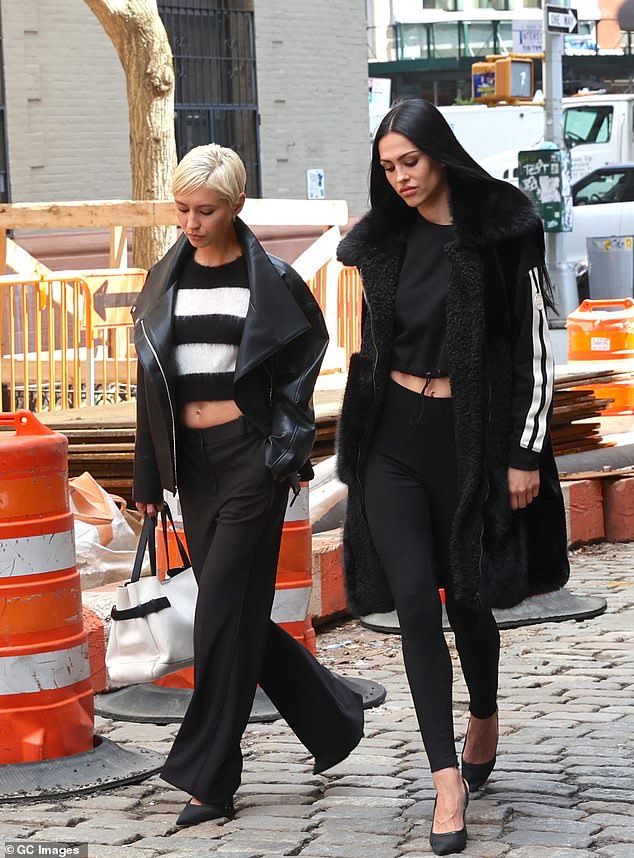 Meanwhile, Amelia modelled a long, black leather trench coat which she layered over a black top and accessorised with an animal-print handbag
