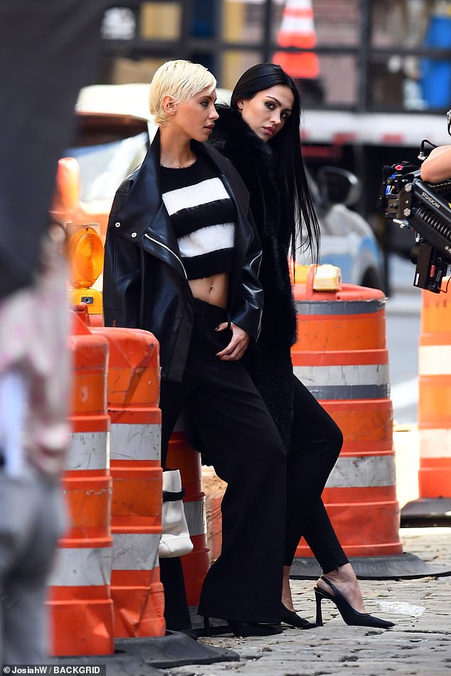 Iris layered her jacket over a striped jumper which she paired with flared trousers and towering heels