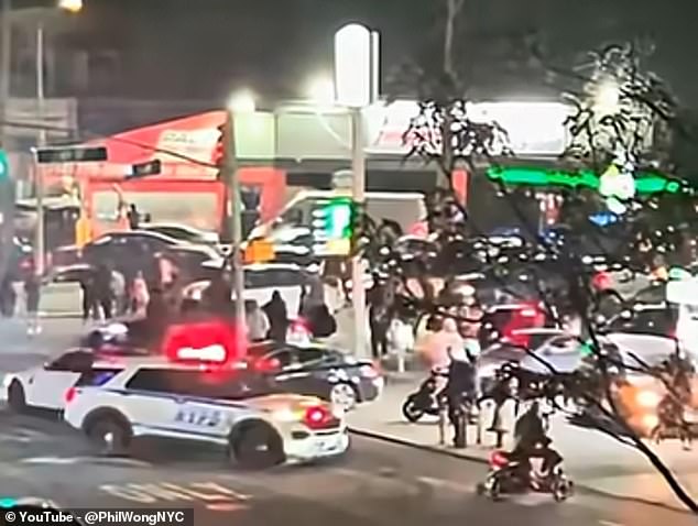 Most vehicles fled, but three individuals jumped on a police car, cracking its windshield before fleeing