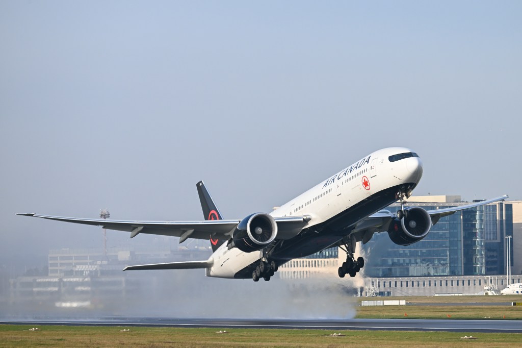 An Air Canada Boeing 777 passenger jet taking off from Brussels Airport.