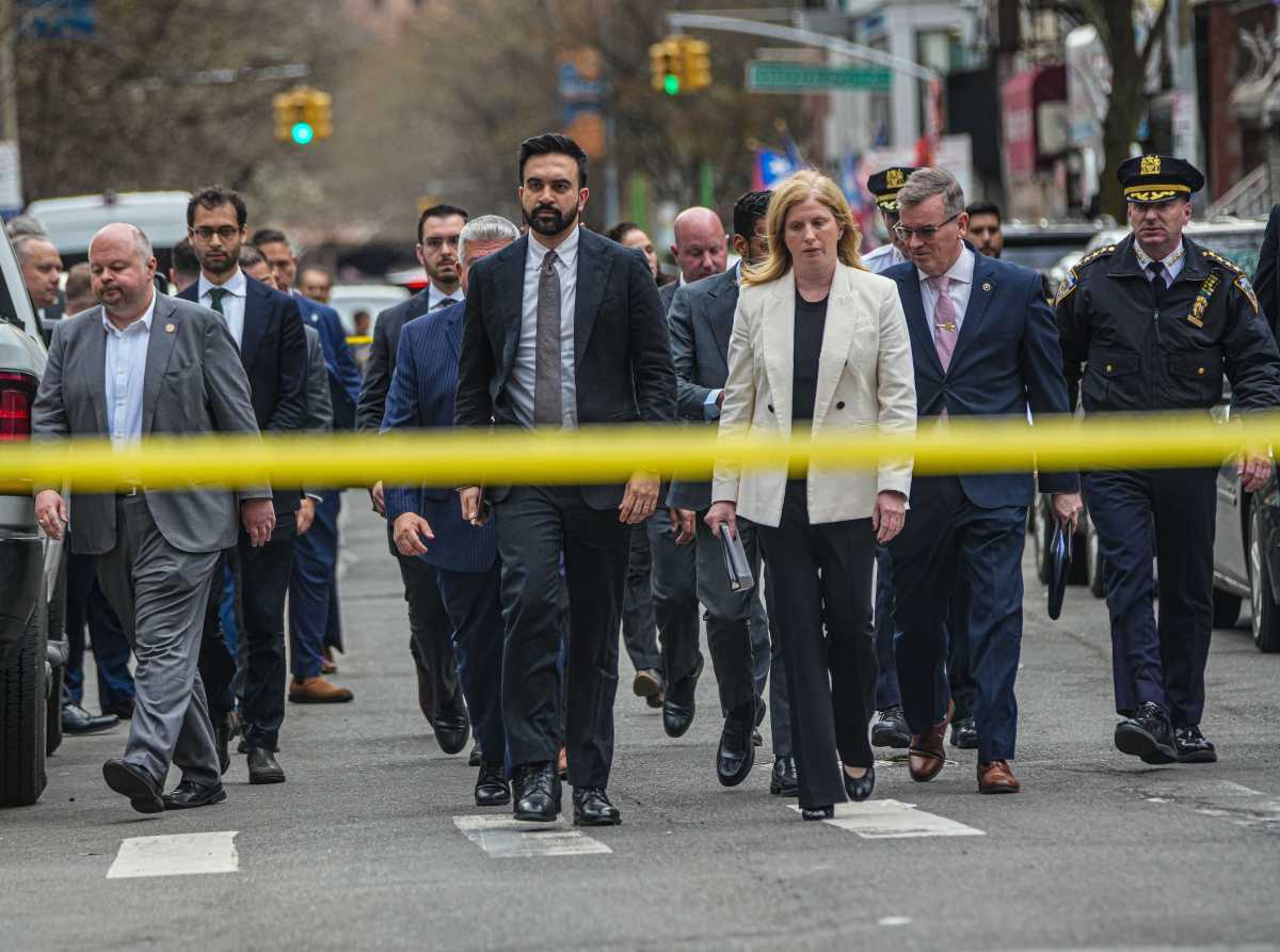 people and police officials at scene of Brooklyn shooting where baby girl was shot dead