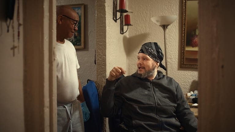 Tommy Rodriguez, right, talks to his relative, Francisco Medina, left,...