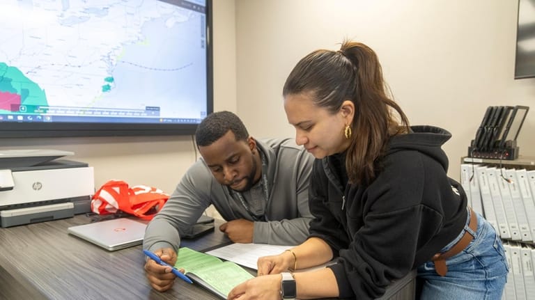 Flight instructor and airline pilot hopeful Gregory Suarez works with...