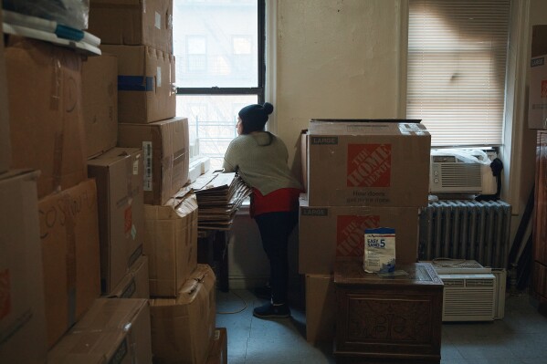 Marina Quiroz looks through the window in an apartment building where tenants report maintenance issues and pest infestations, in the Bronx borough of New York, Tuesday, March 17, 2026. (AP Photo/Andres Kudacki)