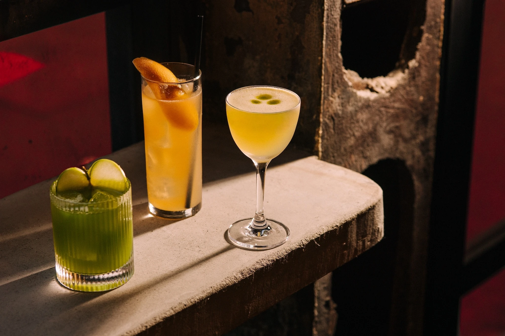 Three drinks on a concrete bar