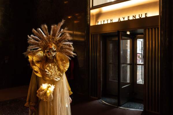 Henrieta Scholtzova stands inside Rockefeller Center during the Easter Bonnet Parade on Fifth Avenue, Sunday, April 5, 2026, in New York. (AP Photo/Adam Gray)