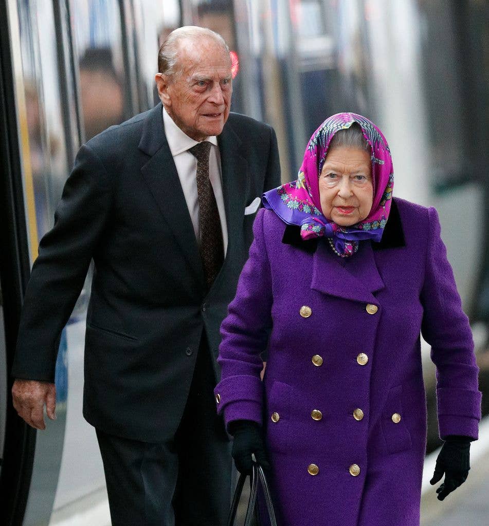 Queen Elizabeth II and Prince Philip, walking on train platform