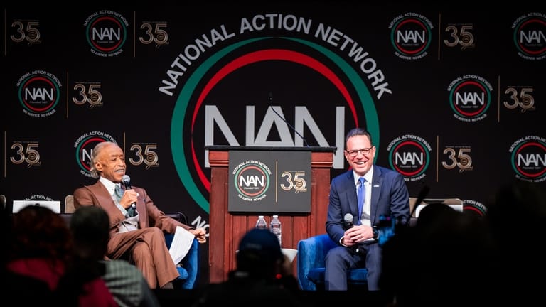 Josh Shapiro, Governor of Pennsylvania, speaks with Reverend Al Sharpton...