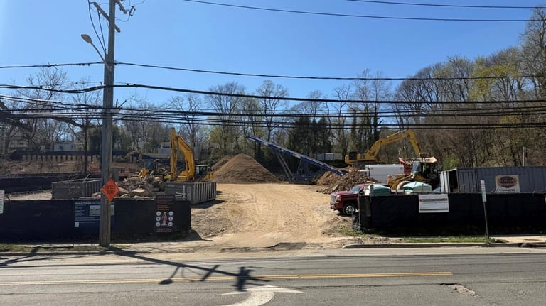 Construction crews work Wednesday at the site of the future...