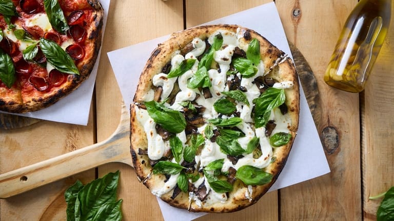 The Gracefully Shroomed pizza, a white pie with mushrooms and...
