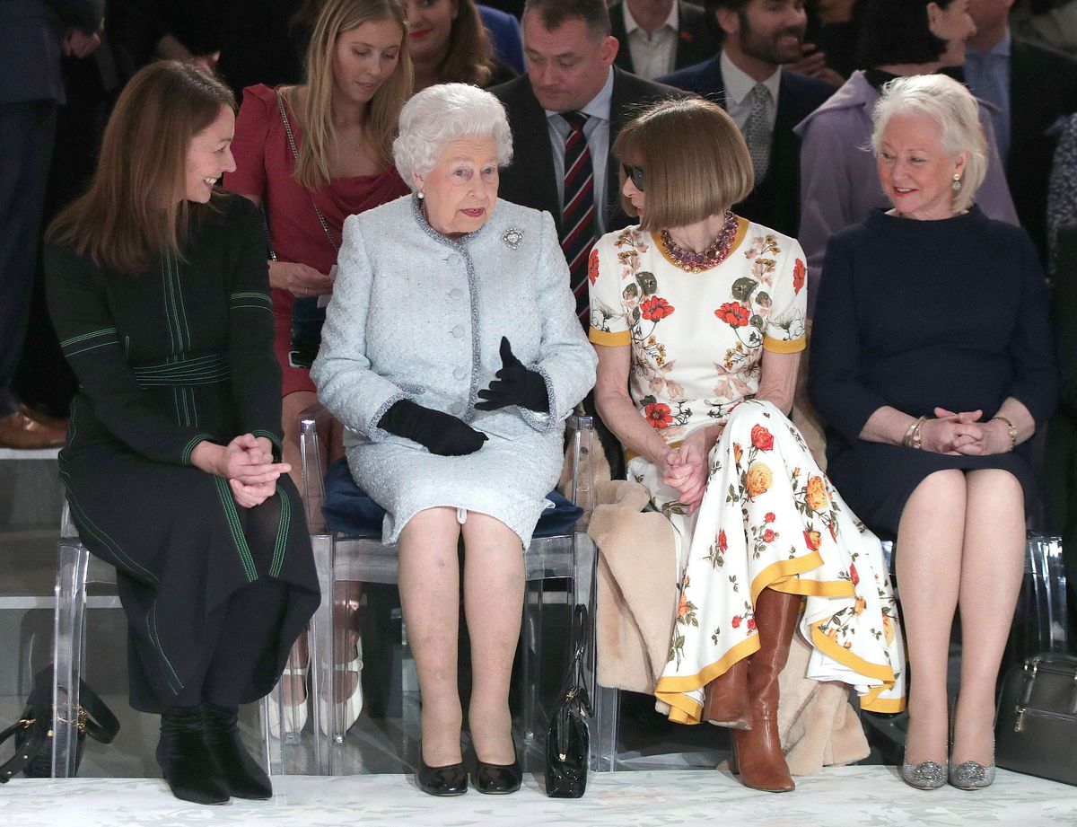 The late Queen at London Fashion Week with Dame Anna Wintour and Angela Kelly in 2018