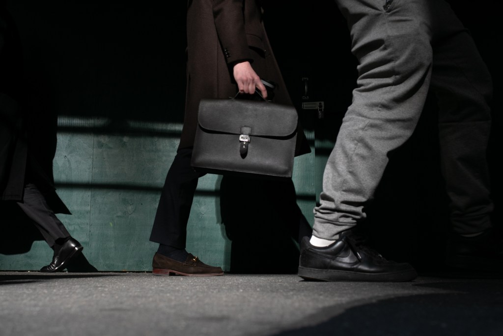 Workers stroll down Wall Street near the Stock Exchange,