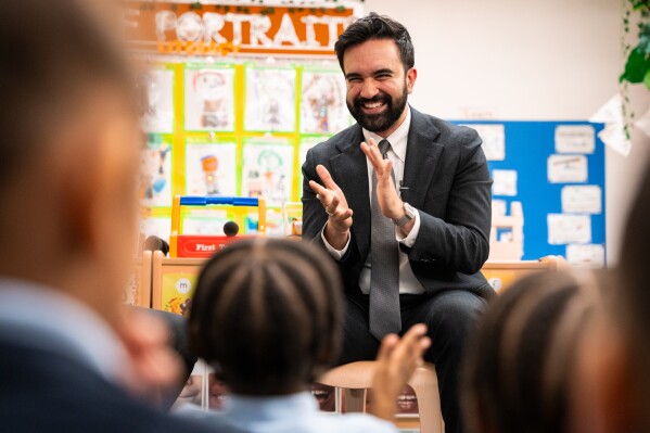 Mayor Zohran Mamdani claps during a visit to Learning Through Play Pre-K with former President Barack Obama in the Bronx in New York, Saturday, April 18, 2026. (AP Photo/Angelina Katsanis)