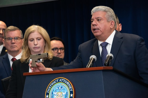 Brooklyn District Attorney Eric Gonzalez and NYPD Commissioner Jessica Tisch display a seized gun as they announce a gang takedown at the Kings County DA's Office in Brooklyn, New York on Wednesday, April 15, 2026. (Gardiner Anderson / New York Daily News)