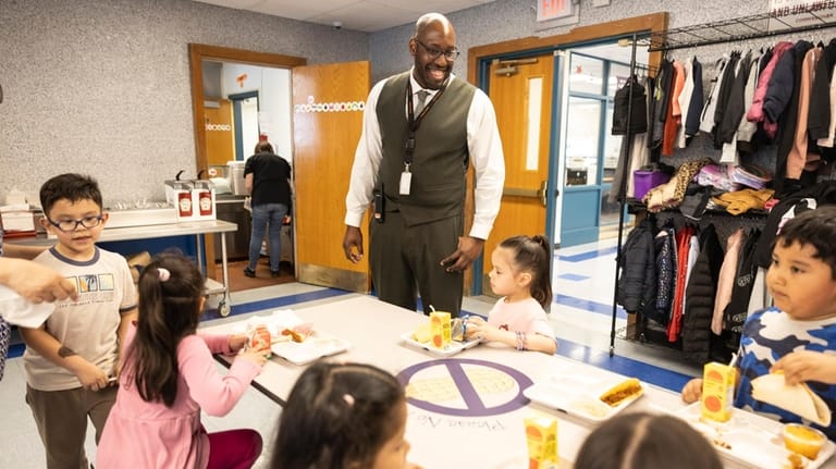 Cordello Avenue Elementary School Principal Nathaniel Marner with students during lunchtime...