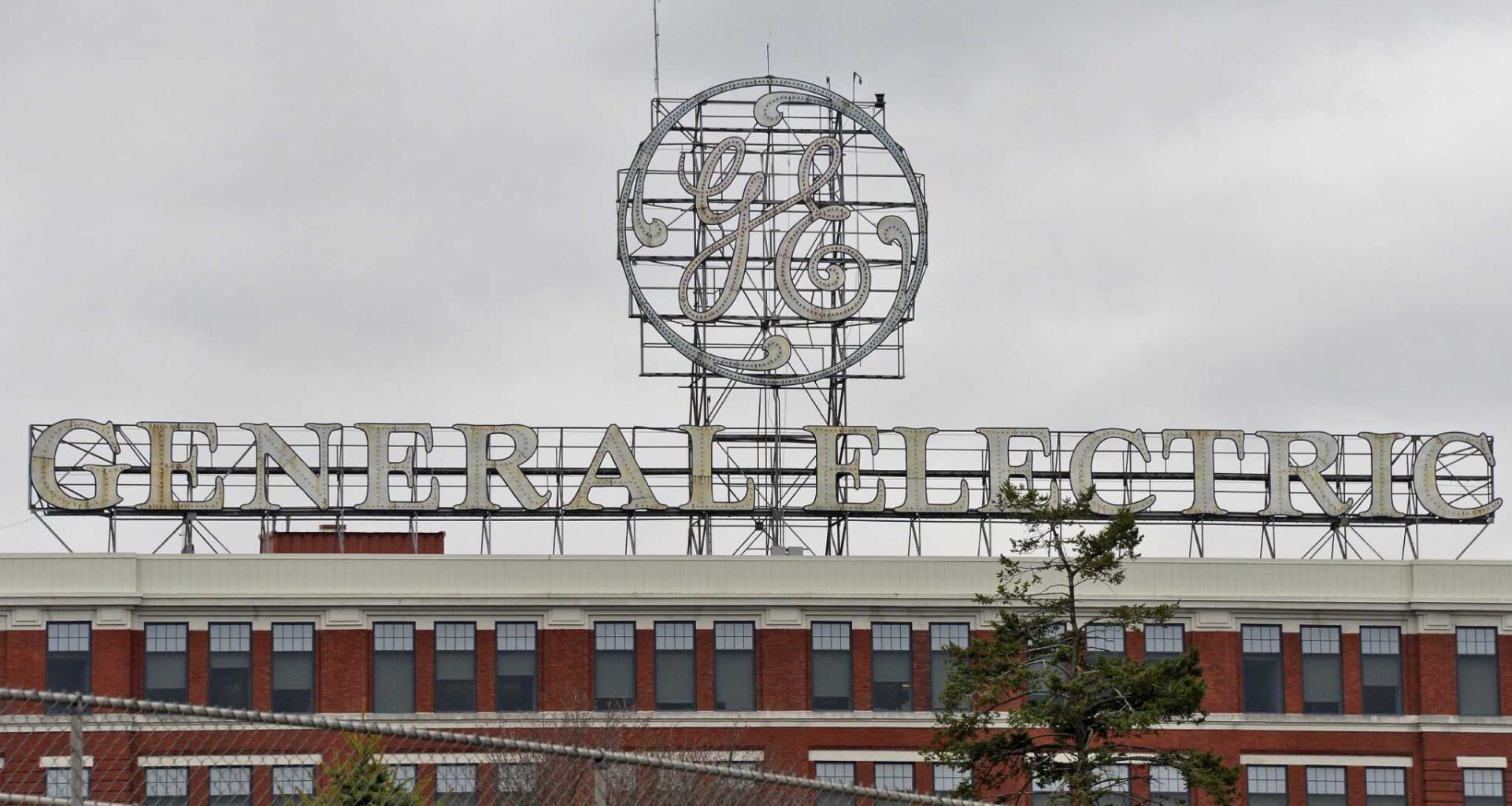 The large GE sign over the company's main plant in Schenectady is coming down to be refurbished, GE Vernova said in a statement. It will return to the top of Building 37 later this spring. (John Carl D'Annibale / Times Union)