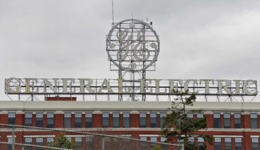 The large GE sign over the company's main plant in Schenectady is coming down to be refurbished, GE Vernova said in a statement. It will return to the top of Building 37 later this spring. (John Carl D'Annibale / Times Union)