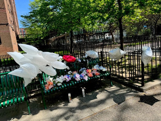 A memorial at the park bench in the Bronx where Edgar Spence, 78, was shot and killed. (Rebecca White / New York Daily News)
