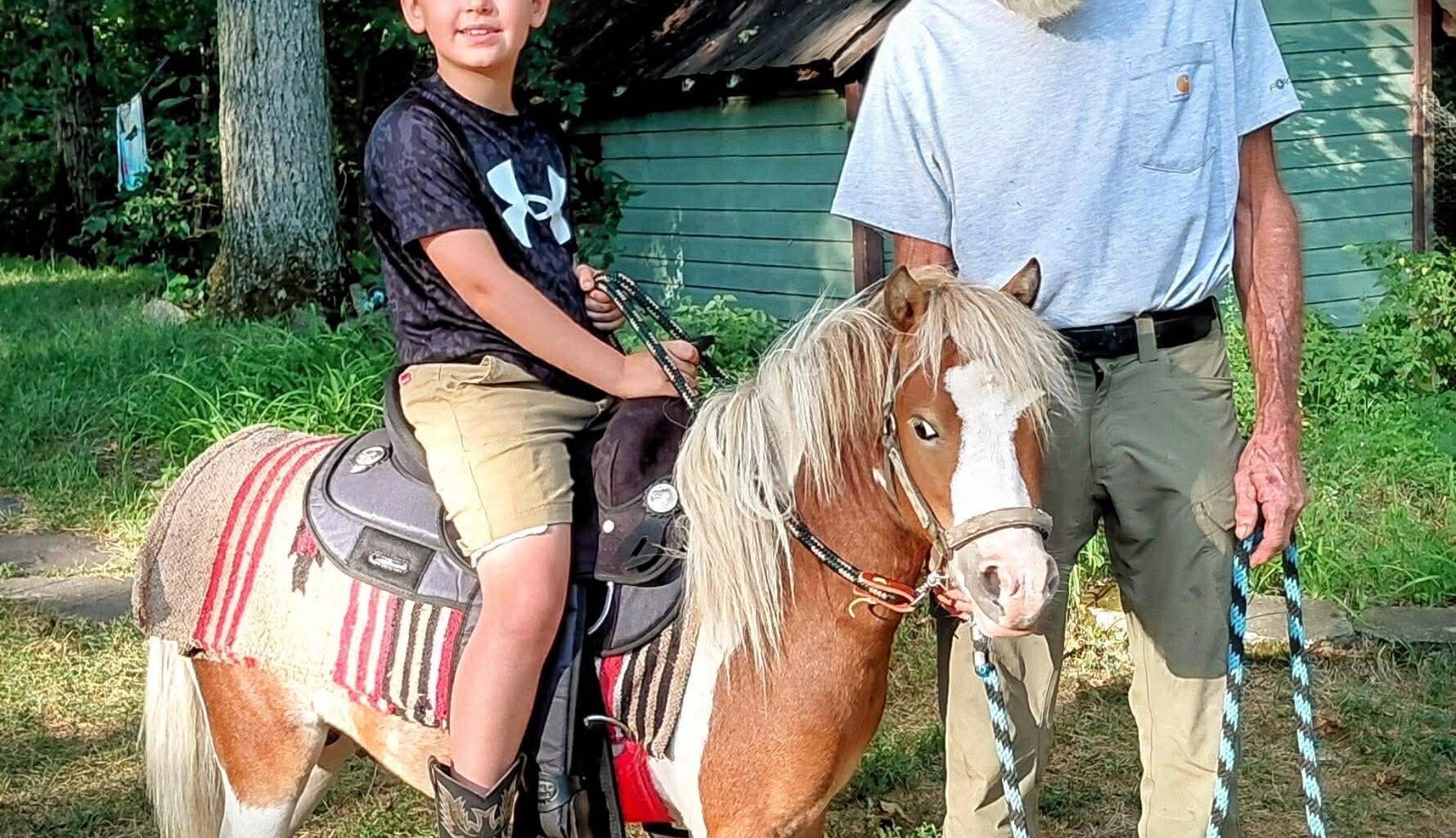 John Monahan, right, is suing Unbridled Sanctuary to get his miniature horse Teddy back after the equine was hit by a train.