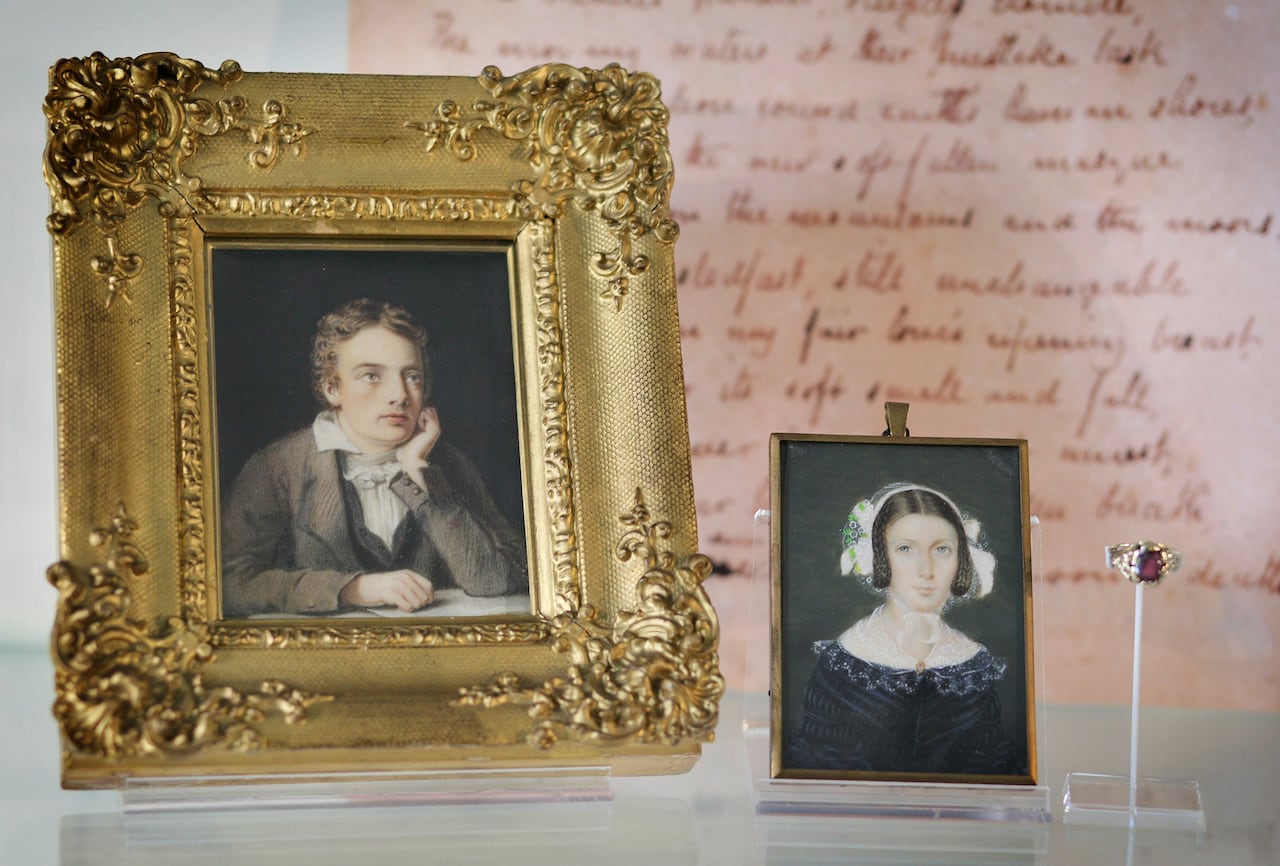 Side-by-side framed portraits of a young man and young woman from the 18th century