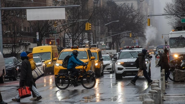 Drivers, bicyclists and pedestrians in the congestion zone in the...