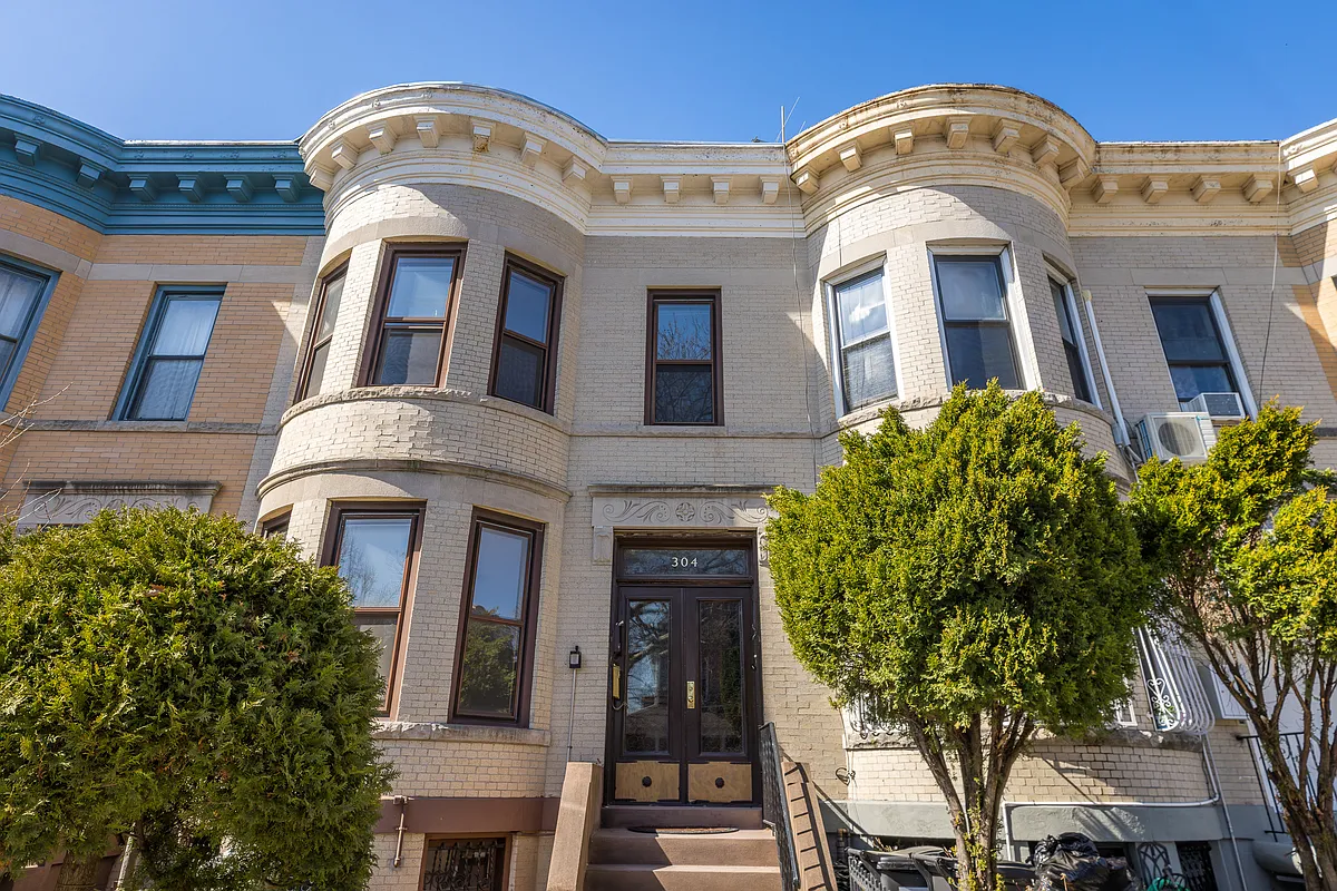 brick row house with a curved bay