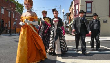 Extras, including three men dressed as woman impersonators, are seen crossing the intersection of Hudson Avenue and Lark Street during the filming of the HBO series “The Gilded Age” on Aug.14, 2024, in Albany. The series will return to the Capital Region in May to film portions of its fourth season.
