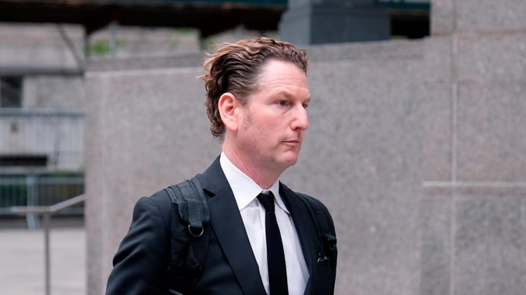 Stefan Pildes walks outside of a courthouse in New York...