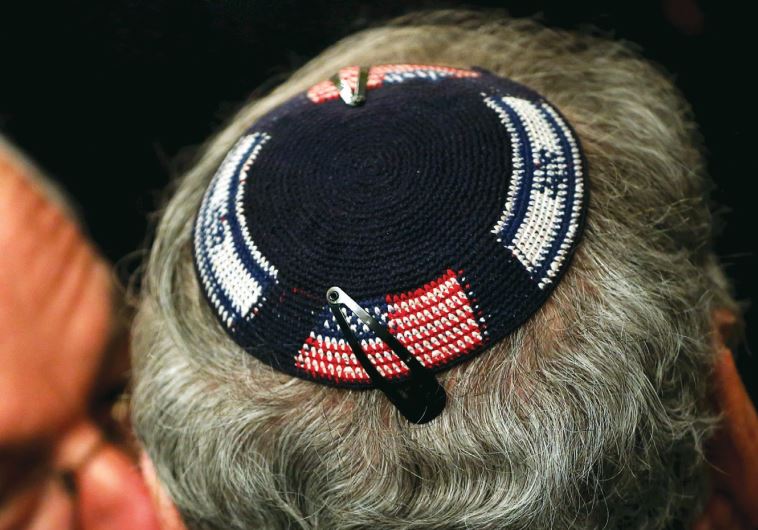 A man wears a kippa embroidered with US and Israeli flags