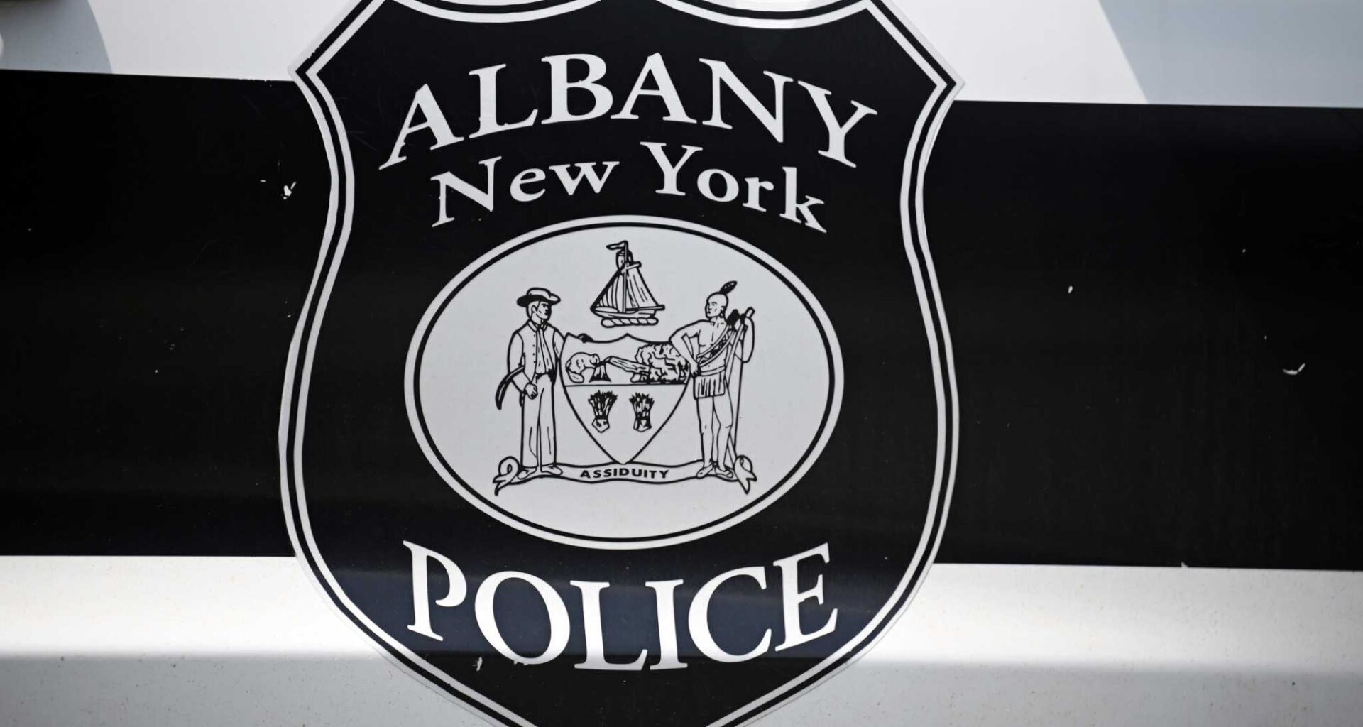 An Albany Police Department shield is pictured on a police car outside the department’s Center Station on Monday, July 28, 2025, on Western Ave. in Albany, N.Y.