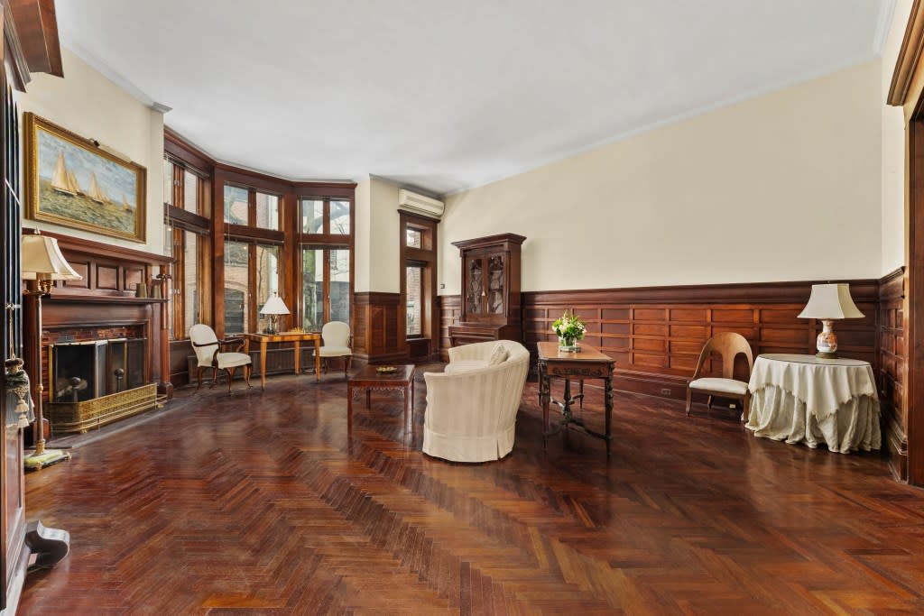A large living room with original wood details. Platinum Forbes Global Properties